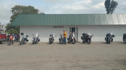 line of motorcycles with man in yellow shirt