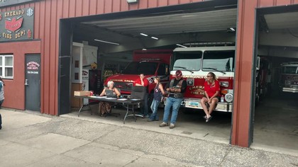 Fire Truck in building garage with people socializing
