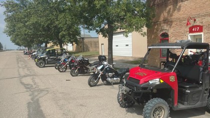red four wheeler with line of motorcycles 