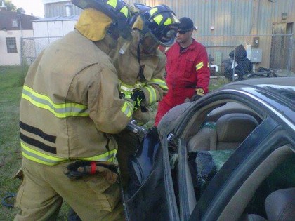 two firefighters in auto extrication training